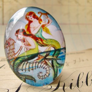 Mermaids on a Seahorse illustration, handmade glass oval cabochon 40x30 40x30mm, orange, yellow, aqua, vintage drawing image 1