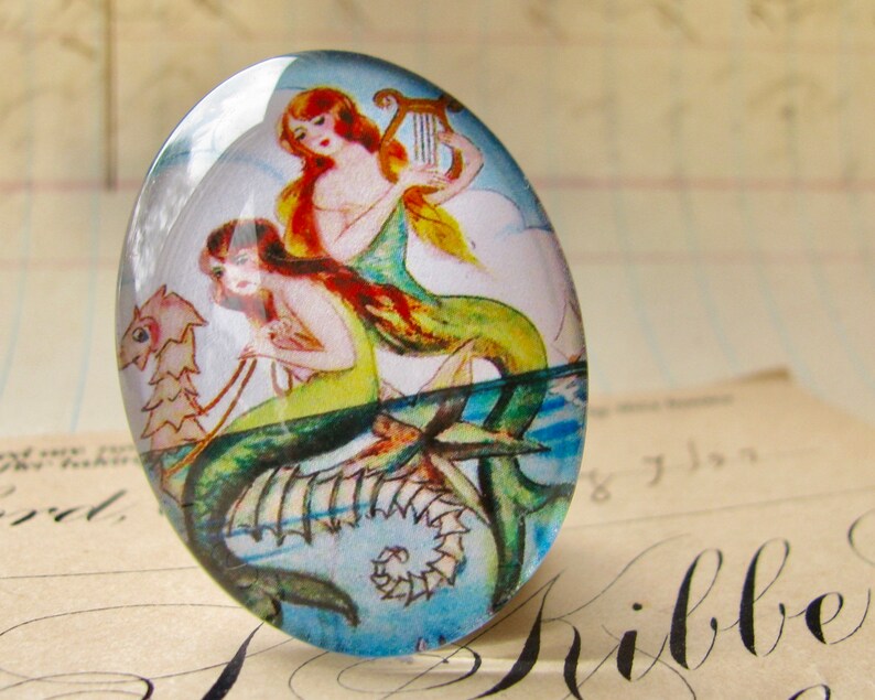 Mermaids on a Seahorse illustration, handmade glass oval cabochon 40x30 40x30mm, orange, yellow, aqua, vintage drawing image 1