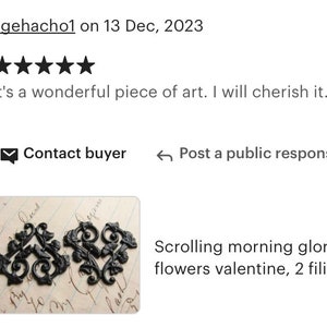 May include: Two black metal filigree scroll designs, resembling morning glory flowers. The designs are on a white background with handwritten text.