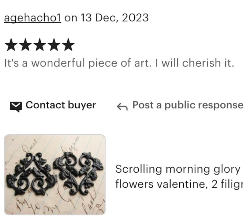 May include: Two black metal filigree scroll designs, resembling morning glory flowers. The designs are on a white background with handwritten text.