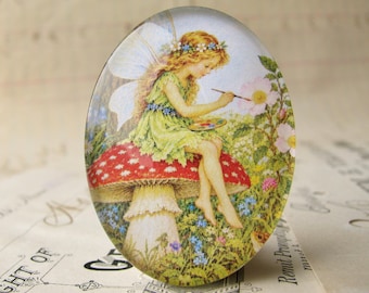 NEW! Fairy painting the flowers, sitting on a toadstool, 40x30mm glass oval cabochon, exclusive to Fallen Angel Brass, handmade in this shop