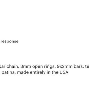 May include: A delicate bar chain featuring 3mm open rings and 9x2mm bars made of textured matte black brass with an oxidized patina. The chain measures 1 foot in length and is presented as a new item, highlighting its detailed construction.