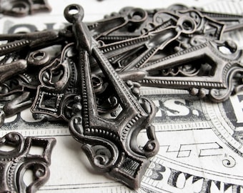 May include: A collection of antique-style metal charms with intricate designs. The charms are made of dark metal and have a distressed finish. They are perfect for adding a vintage touch to jewelry, crafts, or home decor.