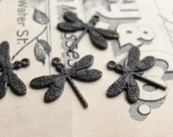 May include: Five antique bronze dragonfly charms with intricate details. Each charm has a loop for attaching to jewelry or other crafts.