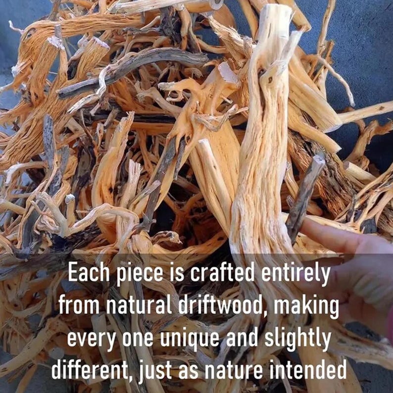 May include: A pile of natural driftwood pieces in various shapes and sizes, with light brown and tan hues. The text on the image reads: "Each piece is crafted entirely from natural driftwood, making every one unique and slightly different, just as nature intended."