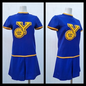 May include: A blue and yellow vintage cheerleading dress with a large yellow "Y" and a basketball with the text "Pam Head" on the front.