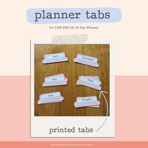 May include: Printed planner tabs with a light blue and pink striped design. The tabs are labeled with months and categories like "April," "Downloads," "May," "Notes," "June," and "Thoughts." The image includes the text "planner tabs" and "printed tabs."
