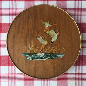 Tin by Smith Crafted Chicago.  Round Tin Featuring Mallard Ducks in Flight on a Wood Veneer Background