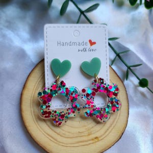 fuchsia and pastel green glitter flower resin earrings