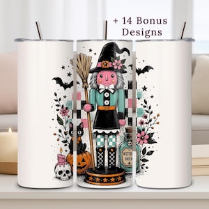 May include: A white cylindrical tumbler featuring a graphic of a witch nutcracker holding a broom, accompanied by a black cat, a jack-o'-lantern, a skull, and a potion bottle labeled Witch Brew. The design includes bats, stars, and flowers.