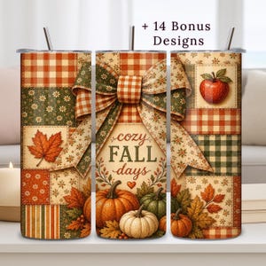 May include: A cylindrical tumbler featuring a patchwork pattern of orange, green, and cream plaid, floral, and striped squares. The design includes a large central bow, pumpkins, autumn leaves, and the text "cozy FALL days" with a small heart.