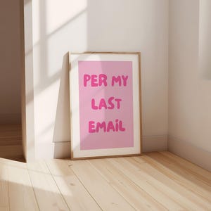 May include: A framed pink poster with the text "PER MY LAST EMAIL" in a bubble font.