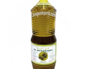 May include: A clear plastic bottle of El Ouazzania Extra Virgin Olive Oil. The bottle is labeled in both Arabic and English. The label features a green olive branch with olives.