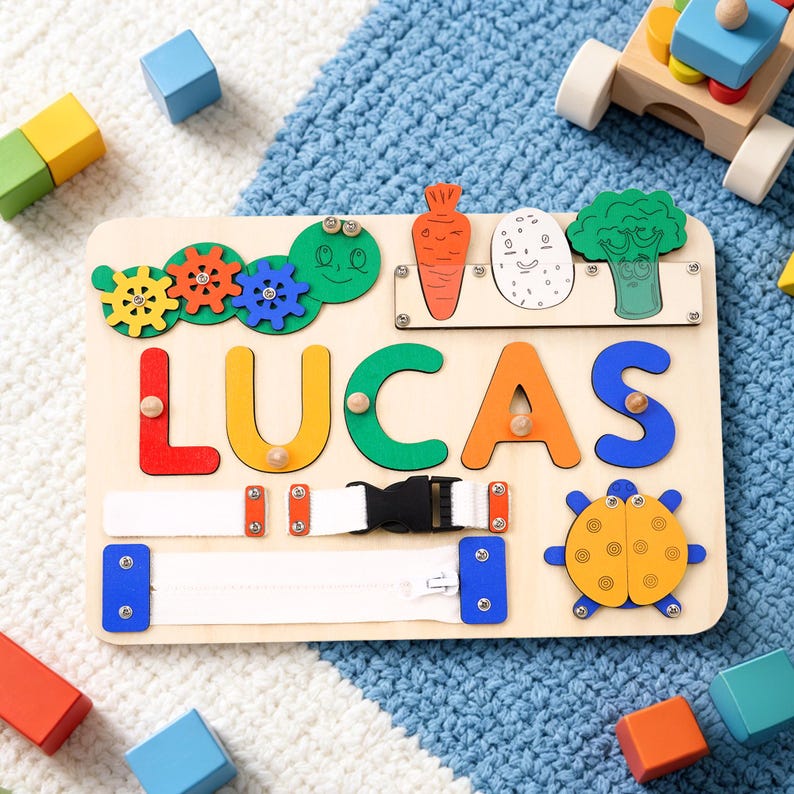 May include: Wooden educational board with the name "LUCAS" in colorful letters. Features include gears, a zipper, a buckle, and vegetable-shaped pieces. A turtle and a carrot are also included. The board is designed for early learning and fine motor skill development.