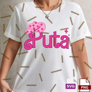 May include: White t-shirt with a pink graphic design. The design features the word "Puta" in a stylized font, accompanied by a pink cowboy hat with star accents. The shirt also includes SVG and PNG file icons.