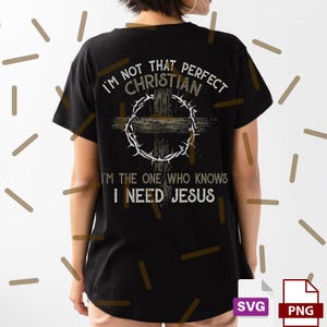 May include: Black t-shirt with the text "I'M NOT THAT PERFECT CHRISTIAN I'M THE ONE WHO KNOWS I NEED JESUS" in white. The design includes a cross and a crown of thorns. The shirt is a casual wear item.