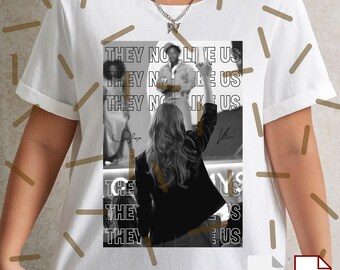May include: White t-shirt featuring a black and white image with the text "THEY NO LIKE US". The image shows a person with their fist raised. The shirt has a crew neck and short sleeves.