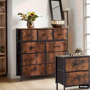 May include: A wooden dresser with nine drawers and a matching nightstand. The drawers have a rustic, wood-grain appearance and black metal handles. The frame is black metal. A vase of flowers sits on top of the dresser.