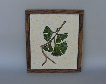 Oak-framed stoneware trivet with imprinted ginkgo branch design