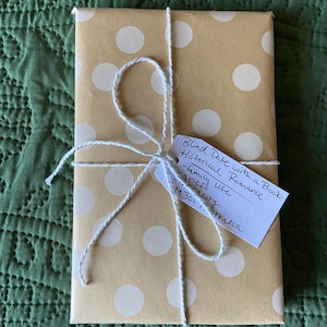 This image shows an exemplar of a book wrapped in brown polka dot wrapping paper in the genre historical romance.
