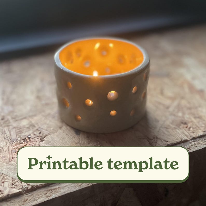 May include: A white ceramic candle holder with a yellow interior and a pattern of small holes. The candle holder is lit with a small candle inside.