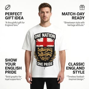 May include: White t-shirt with a graphic of the English flag, the words "ONE NATION" and "ONE PRIDE". The design includes a red cross, three gold lions, and a black shield. The shirt is worn by a person.