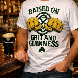 May include: White t-shirt with the text "RAISED ON GRIT AND GUINNESS" in green, featuring two yellow fists and a green shamrock. A pint of Guinness stout sits on a wooden bar. The words "IRISH PUB STYLE" are at the bottom.
