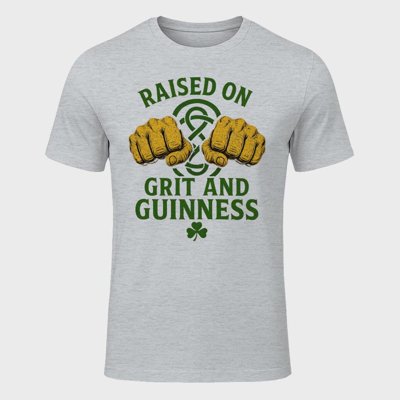 May include: A light gray t-shirt with the text "RAISED ON GRIT AND GUINNESS" in green. The design includes two fists, a Celtic knot, and a shamrock.