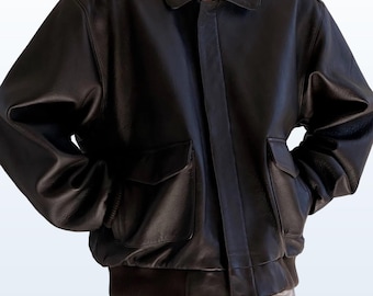 May include: A brown leather bomber jacket with a zipper closure and two pockets. The jacket has a ribbed knit collar, cuffs, and waistband.