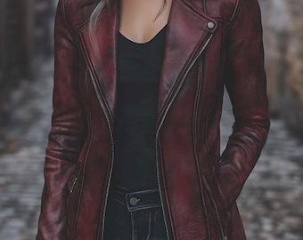 May include: A burgundy leather jacket with a classic asymmetrical zip closure. The jacket features a notched collar, zippered pockets, and a tailored fit. The model is wearing a black top and dark wash jeans.