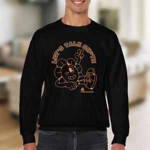 May include: Black sweatshirt with an orange graphic of a cartoon flower character with the text "Let's Talk Sh*t!"