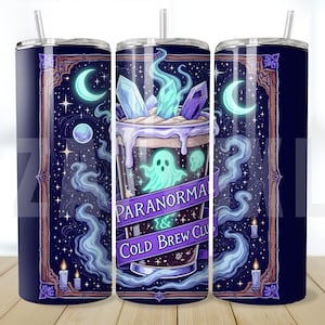 May include: A tall, insulated tumbler with a spooky design. The tumbler features a dark blue background with a graphic of a cold brew coffee drink with a ghost, crystals, and the text "Paranormal & Cold Brew Club". The design includes moons, stars, and candles.