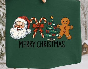 Könnte beinhalten: Grüner Stoff mit Weihnachtsmotiven mit Weihnachtsmann, Zuckerstangen, Weihnachtsbaum und Lebkuchenmann. Die Worte "MERRY CHRISTMAS" sind unter den Illustrationen aufgedruckt. Der Stoff wird von einer Hand gehalten.