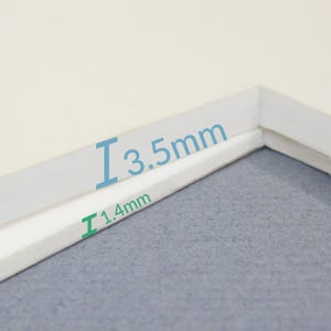 May include: Close-up of two white pieces of paper with a corner edge. The top piece of paper is 3.5 mm thick and the bottom piece is 1.4 mm thick.