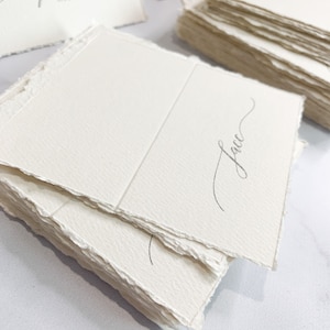 a table topped with lots of white cards