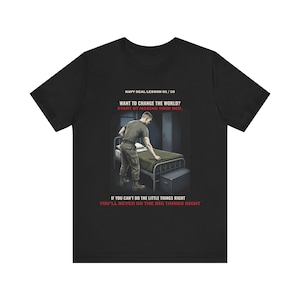 May include: A black short-sleeve t-shirt featuring a graphic of a person in uniform making a bed. The text reads: NAVY SEAL LESSON 01 / 10, WANT TO CHANGE THE WORLD? START BY MAKING YOUR BED. IF YOU CAN'T DO THE LITTLE THINGS RIGHT YOU'LL NEVER DO THE BIG THINGS RIGHT.