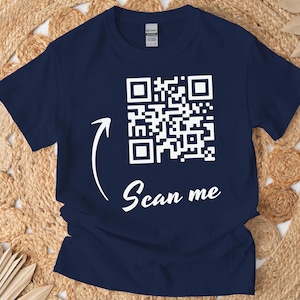 May include: A navy blue t-shirt with a white QR code and the text "Scan me" printed on the front.