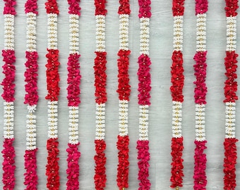 Handgemaakte Indiase bloemenslinger – rood-roze poojadecor met gouden belletjes