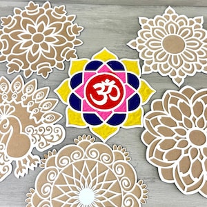 May include: Six brown cardboard cutouts of mandala designs, one with a peacock design, and one with a pink, yellow, blue, and red mandala with the symbol "Om" in the centre.