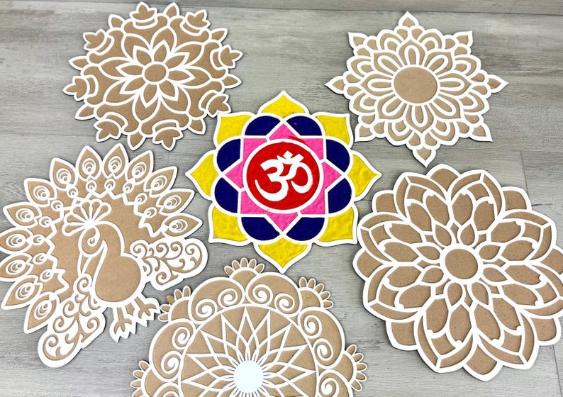 May include: Six brown cardboard cutouts of mandala designs, one with a peacock design, and one with a pink, yellow, blue, and red mandala with the symbol "Om" in the centre.