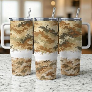 May include: Three stainless steel travel mugs with handles and lids. The mugs feature a camouflage pattern in shades of brown, tan, and green. A white band separates the camouflage design from the bottom. Each mug has a silver straw.