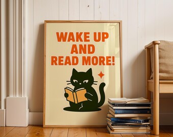 May include: A black cat reading a book with the text "Wake up and read more!" on a beige background. The cat is sitting on a stack of books.