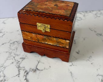 Vintage wooden trinket box. with carved decorative scallops and floral art.