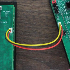 May include: Two green circuit boards with black connectors and red and yellow wires connecting them. The boards have the text "Eurorack Power" printed on them. A grey ribbon cable with red and orange connectors is attached to the boards.