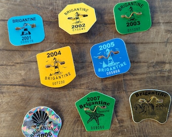 Set of 8 vintage Brigantine Beach NJ beach tags badges 2001-2008