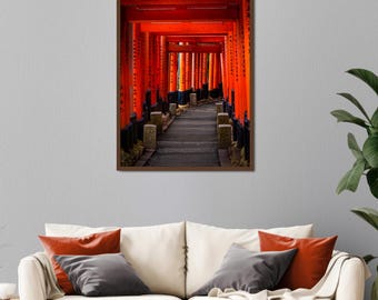 May include: A framed print of a pathway lined with vibrant orange torii gates, creating a tunnel effect. The image captures the architectural beauty of a Japanese shrine, with a stone path leading into the distance. The artwork is displayed above a cream-colored sofa.