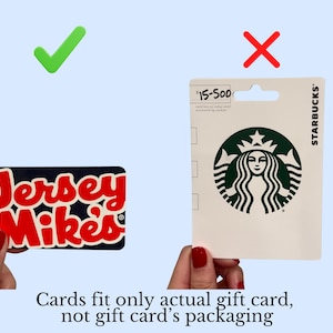May include: A rectangular Jersey Mike's gift card with a dark blue background and red lettering, positioned next to a white Starbucks gift card in its original retail packaging. Text at the bottom reads: Cards fit only actual gift card, not gift card's packaging.