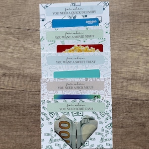May include: A set of five white gift card holders with various themed patterns and text. Each holder features the phrase for when followed by specific occasions including quick delivery, movie night, sweet treat, pick me up, and some cash.