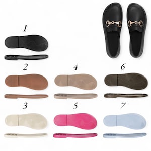 May include: A collection of shoe soles in various colors, including black, brown, beige, pink, and light blue. The image also shows a pair of black loafers with gold-colored hardware.