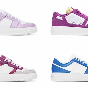 May include: Four pairs of sneakers with white soles and different colored accents. The sneakers have a white base with a colored panel on the side and a colored heel. The colors are purple, pink, blue, and red.